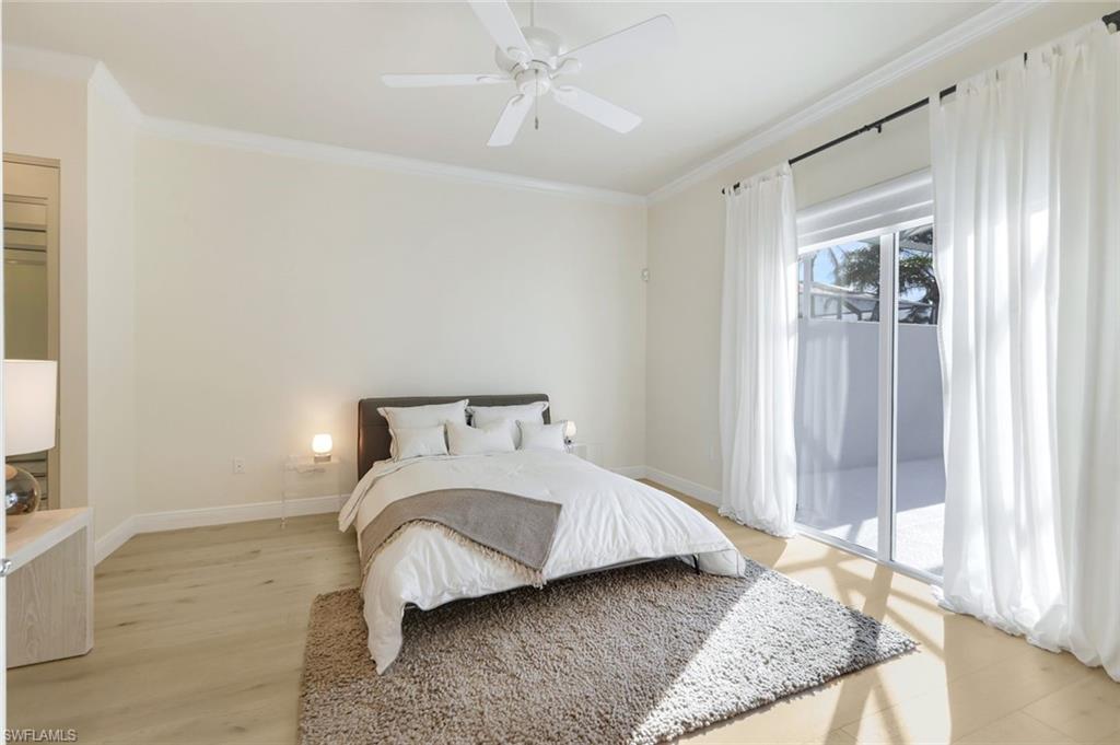 7063 Toscana Court Naples, FL 34114 - Photo 22 of 47 Bedroom featuring access to outside, crown molding, light wood-style floors, and a ceiling fan