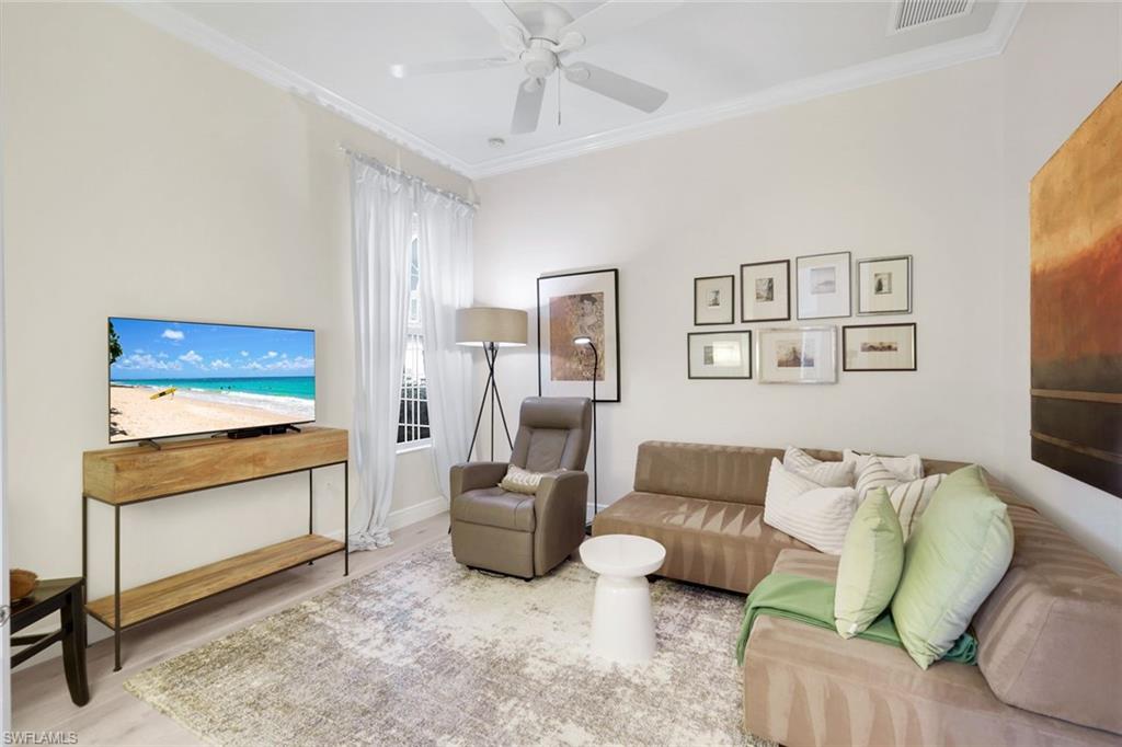 7063 Toscana Court Naples, FL 34114 - Photo 27 of 47 Living room featuring ornamental molding, a ceiling fan, and wood finished floors