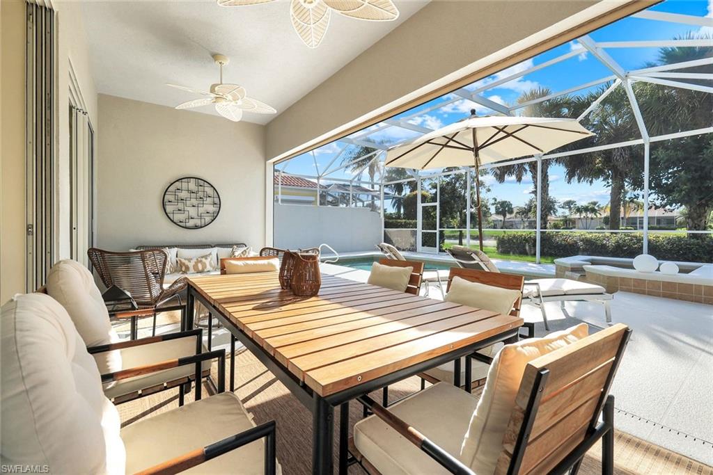 7063 Toscana Court Naples, FL 34114 - Photo 32 of 47 View of patio with an outdoor pool, a sunroom, an outdoor hangout area, and glass enclosure