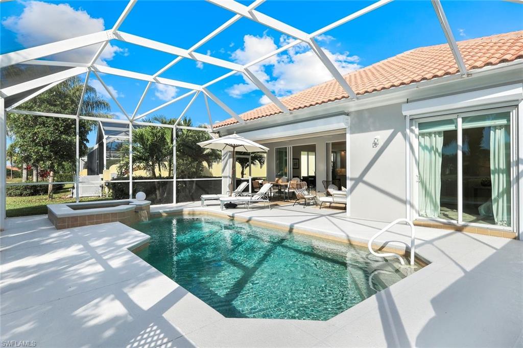 7063 Toscana Court Naples, FL 34114 - Photo 36 of 47 View of pool with a patio area, a sunroom, a lanai, and a pool with connected hot tub
