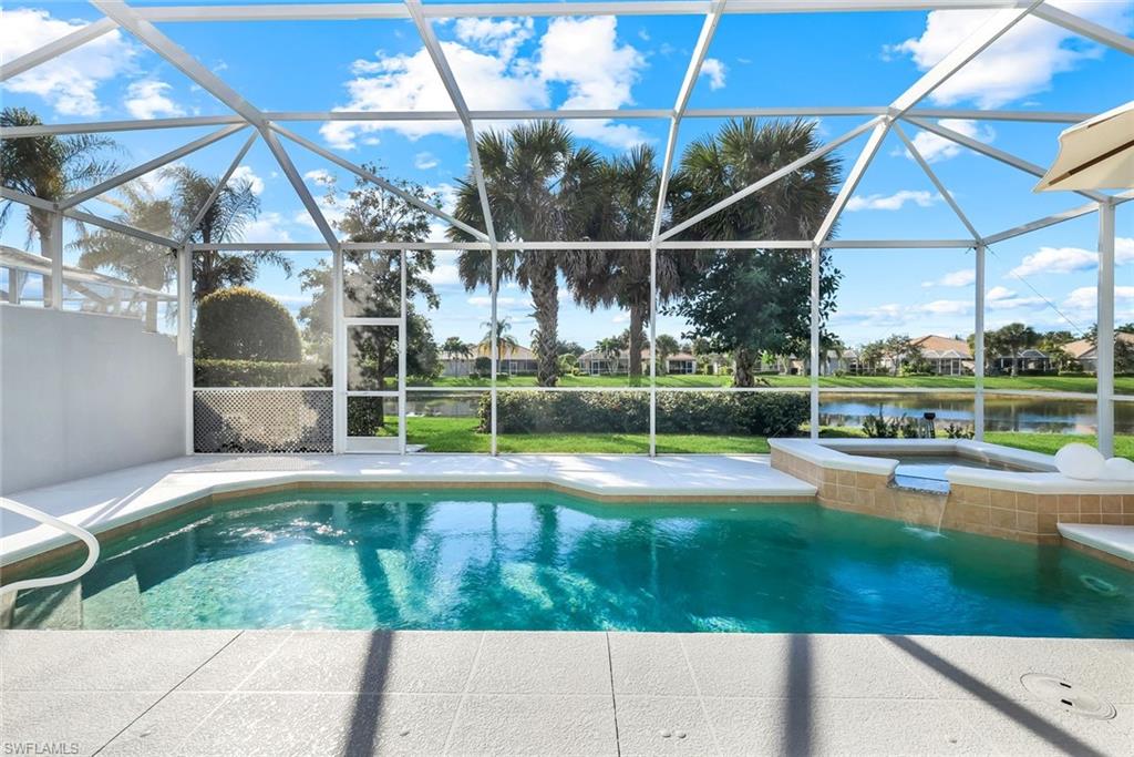 7063 Toscana Court Naples, FL 34114 - Photo 37 of 47 Swimming pool with a sunroom, a water view, glass enclosure, a patio area, and an in-ground hot tub