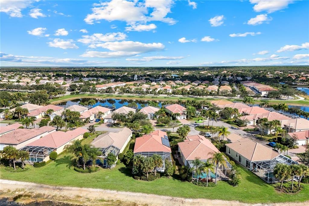 7063 Toscana Court Naples, FL 34114 - Photo 42 of 47 Aerial perspective of suburban area with a nearby body of water
