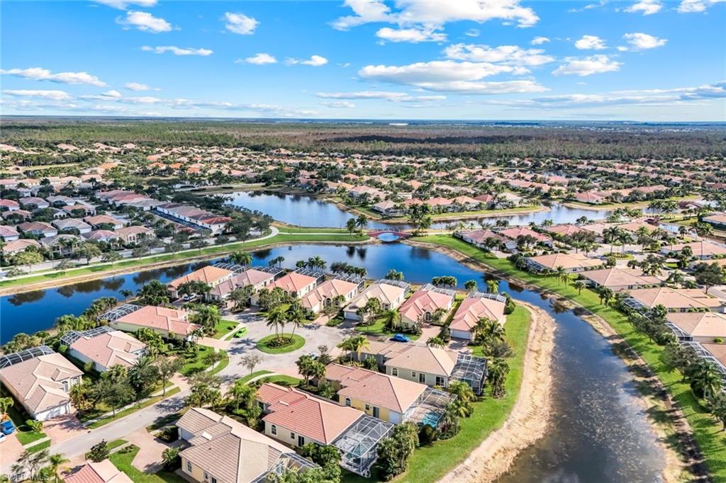 7063 Toscana Court Naples, FL 34114 - Photo 43 of 47 Aerial view of residential area with a nearby body of water