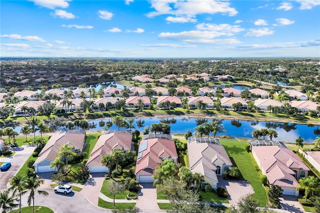 7063 Toscana Court Naples, FL 34114 - Photo 44 of 47 Aerial perspective of suburban area featuring a large body of water