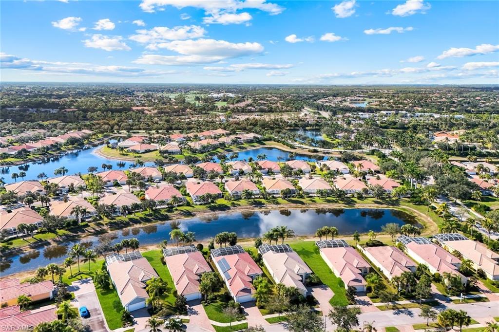 7063 Toscana Court Naples, FL 34114 - Photo 45 of 47 Aerial view of property and surrounding area with nearby suburban area and a large body of water