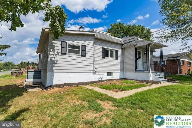 a view of a house with pool and chairs