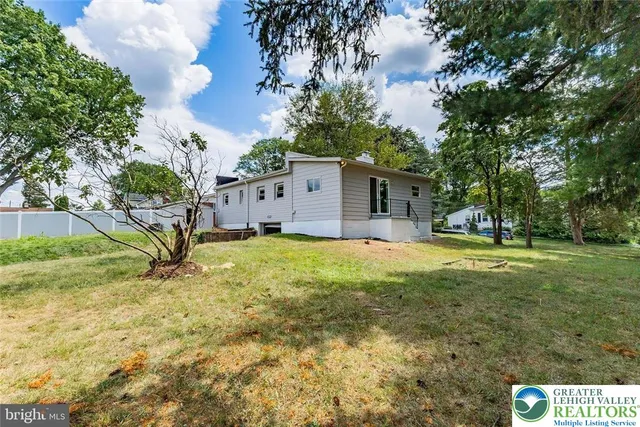 a house view with swimming pool in front of it