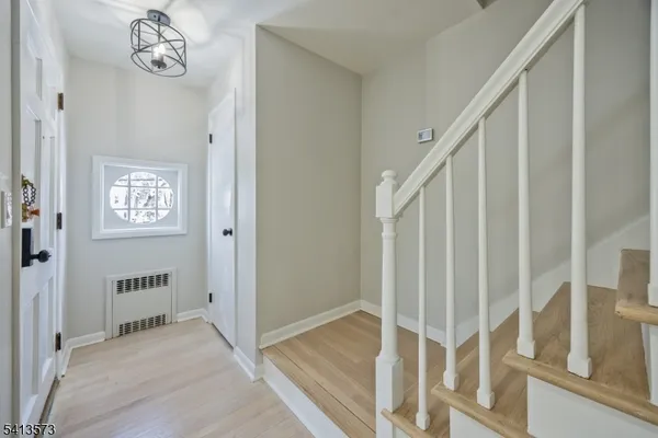a view of a hallway with entryway wooden floor and entryway