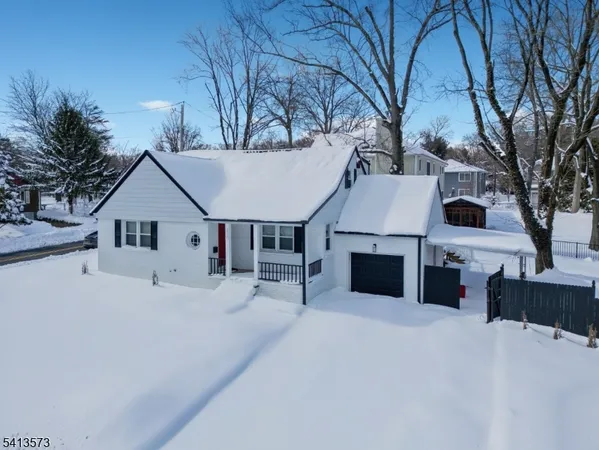 a view of a house with a yard covered with snow in front of house