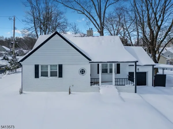 a view of a house with a yard covered in snow