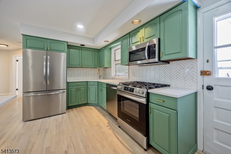 252 Knickerbocker Road Closter, NJ 07624 - Photo 5 of 27 a kitchen with a stove top oven cabinets and a refrigerator