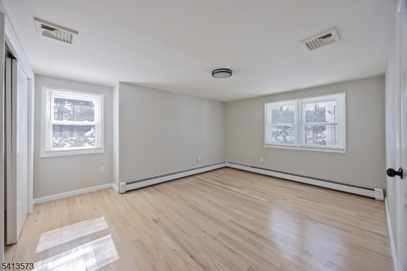 252 Knickerbocker Road Closter, NJ 07624 - Photo 8 of 27 a view of an empty room with wooden floor and a window