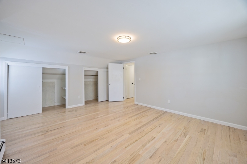 252 Knickerbocker Road Closter, NJ 07624 - Photo 9 of 27 a view of an empty room with wooden floor