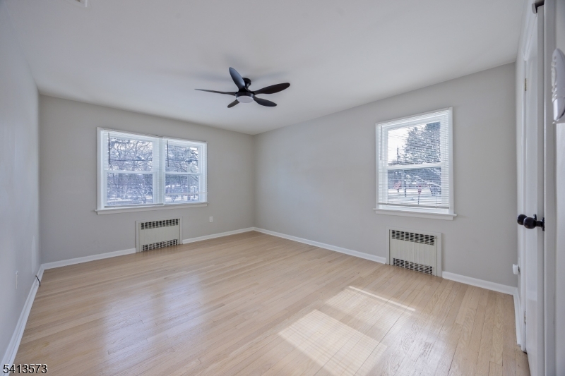 252 Knickerbocker Road Closter, NJ 07624 - Photo 10 of 27 a view of an empty room with a window and a kitchen