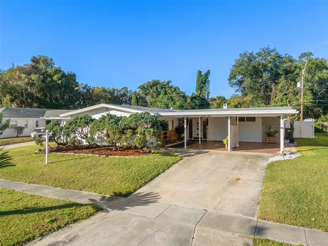 a view of a house with swimming pool and a yard