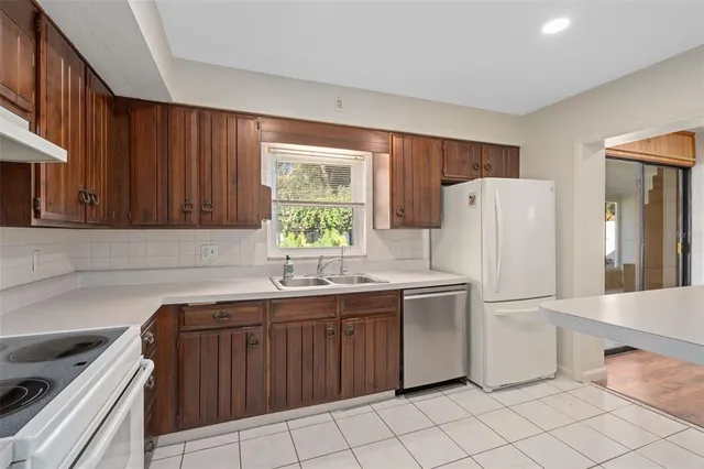 a kitchen with a stove sink and cabinets