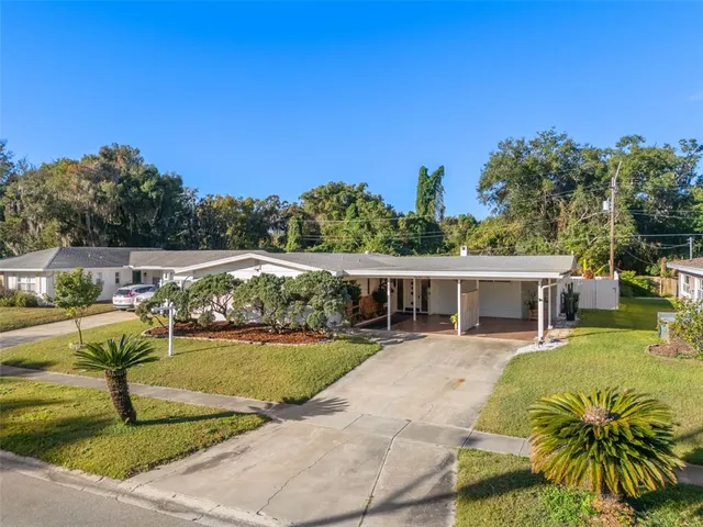 a view of a house with swimming pool and sitting area