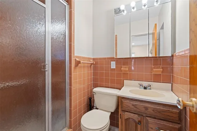 a view of a house with a yard and potted plants
