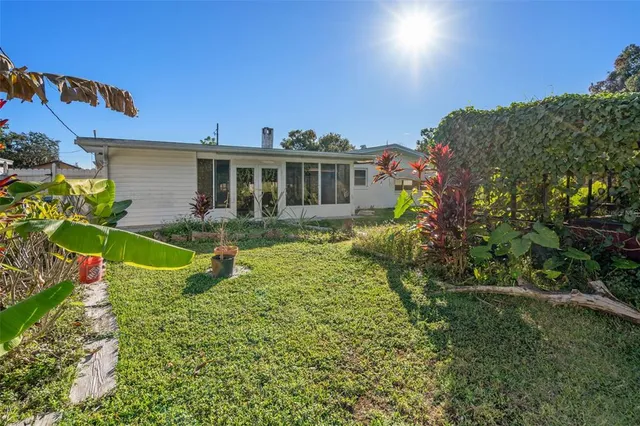 a view of a house with a backyard