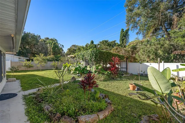 an aerial view of residential houses with yard