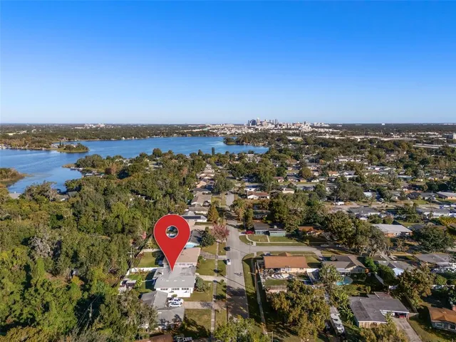 an aerial view of a house with a yard and potted plants