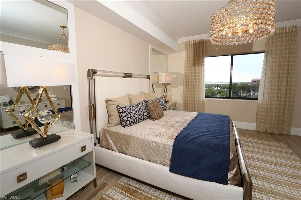 1135 3rd Avenue South, Unit 517 Naples, FL 34102 - Photo 11 of 35 a bedroom with a large bed and a window