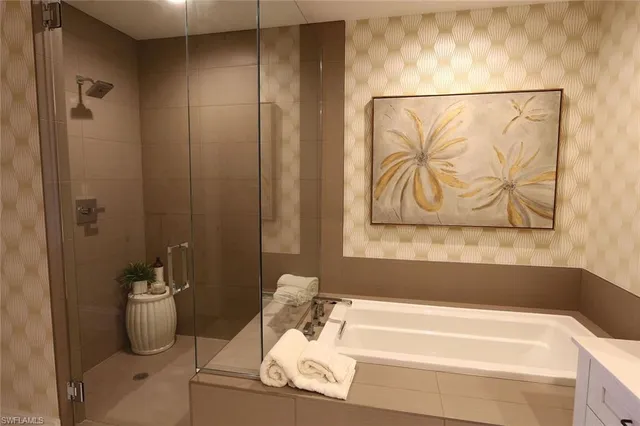 a bathroom with a bathtub and a shower