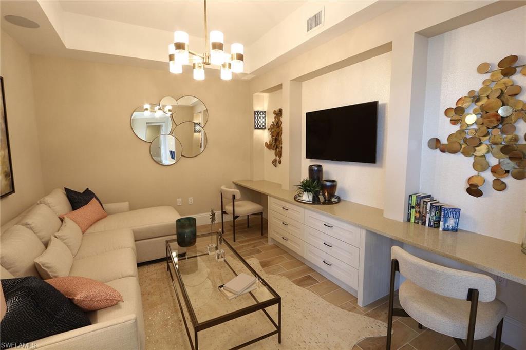 1135 3rd Avenue South, Unit 517 Naples, FL 34102 - Photo 16 of 35 a living room with furniture and a flat screen tv