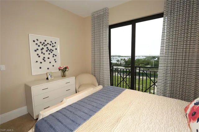 a bedroom with a large bed and a large window