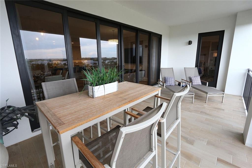 1135 3rd Avenue South, Unit 517 Naples, FL 34102 - Photo 24 of 35 a view of a dining room with furniture window and wooden floor