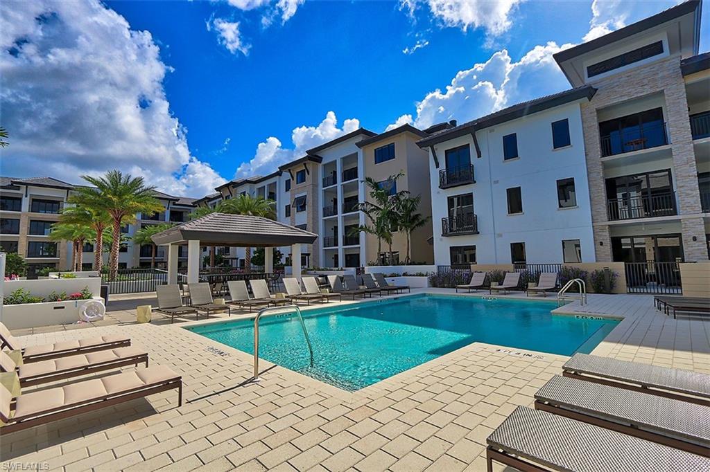 1135 3rd Avenue South, Unit 517 Naples, FL 34102 - Photo 27 of 35 a view of a house with swimming pool and sitting area