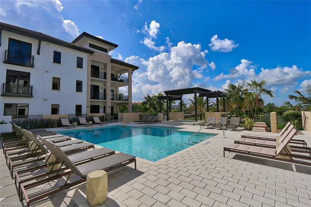 1135 3rd Avenue South, Unit 517 Naples, FL 34102 - Photo 28 of 35 a view of a patio with swimming pool table and chairs