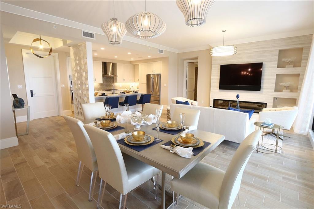 1135 3rd Avenue South, Unit 517 Naples, FL 34102 - Photo 5 of 35 a living room with furniture kitchen view and a flat screen tv