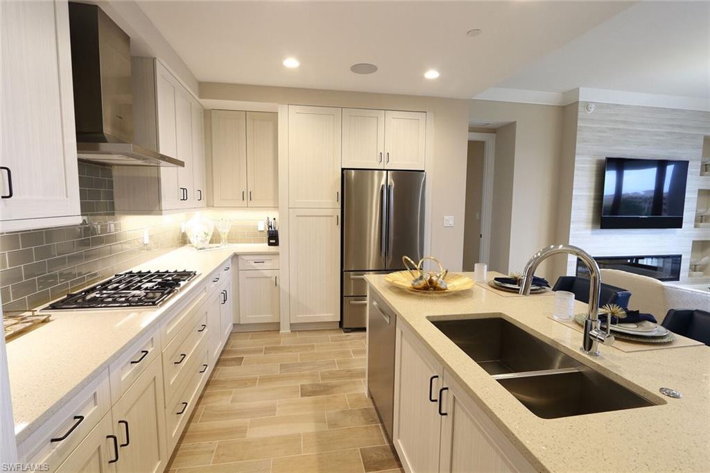 1135 3rd Avenue South, Unit 517 Naples, FL 34102 - Photo 9 of 35 a kitchen with a sink stove and refrigerator