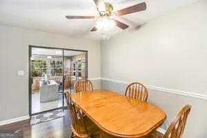 a view of a dining room with furniture wooden floor and chandelier