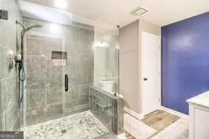 a bathroom with a shower and a sink