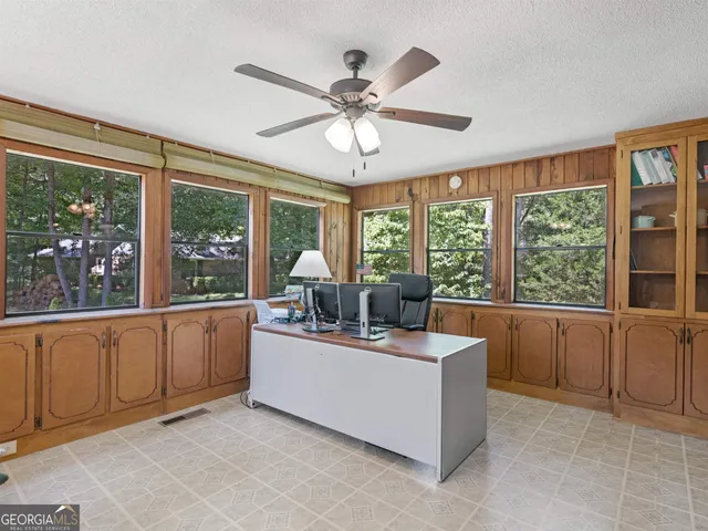 a living room with kitchen furniture and a large window