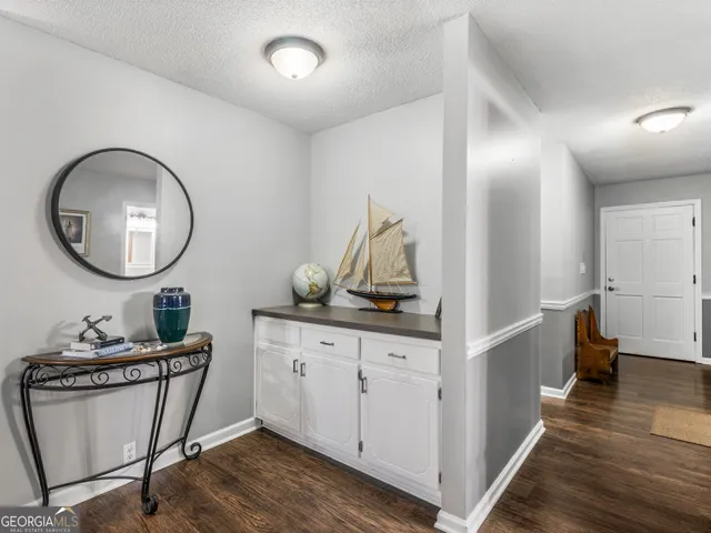 a very nice looking room with wooden floor and furniture