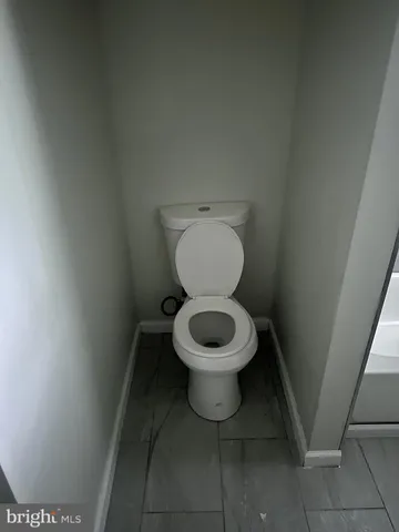 a white toilet sitting in a bathroom