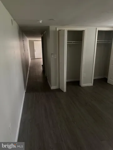 an empty room with wooden floor and closet