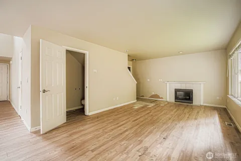 a view of a kitchen with a refrigerator and a stove top oven
