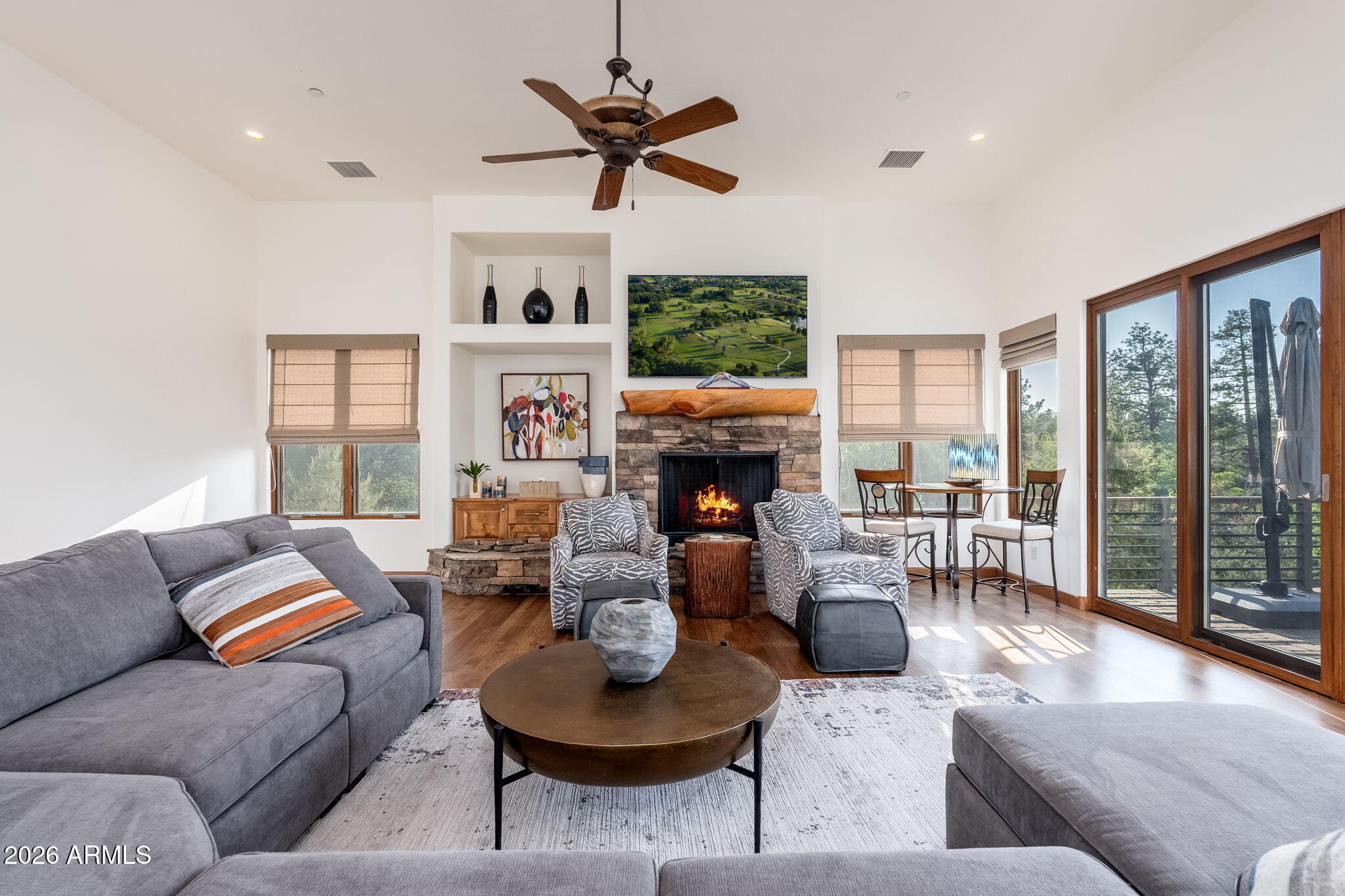 2208 East Filaree Circle Payson, AZ 85541 - Photo 6 of 60 a living room with furniture a fireplace and a large window