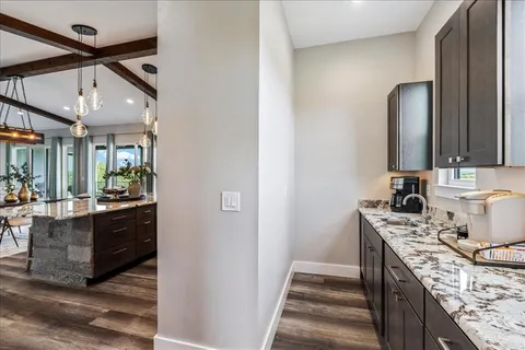 a bathroom with a granite countertop sink a mirror and vanity