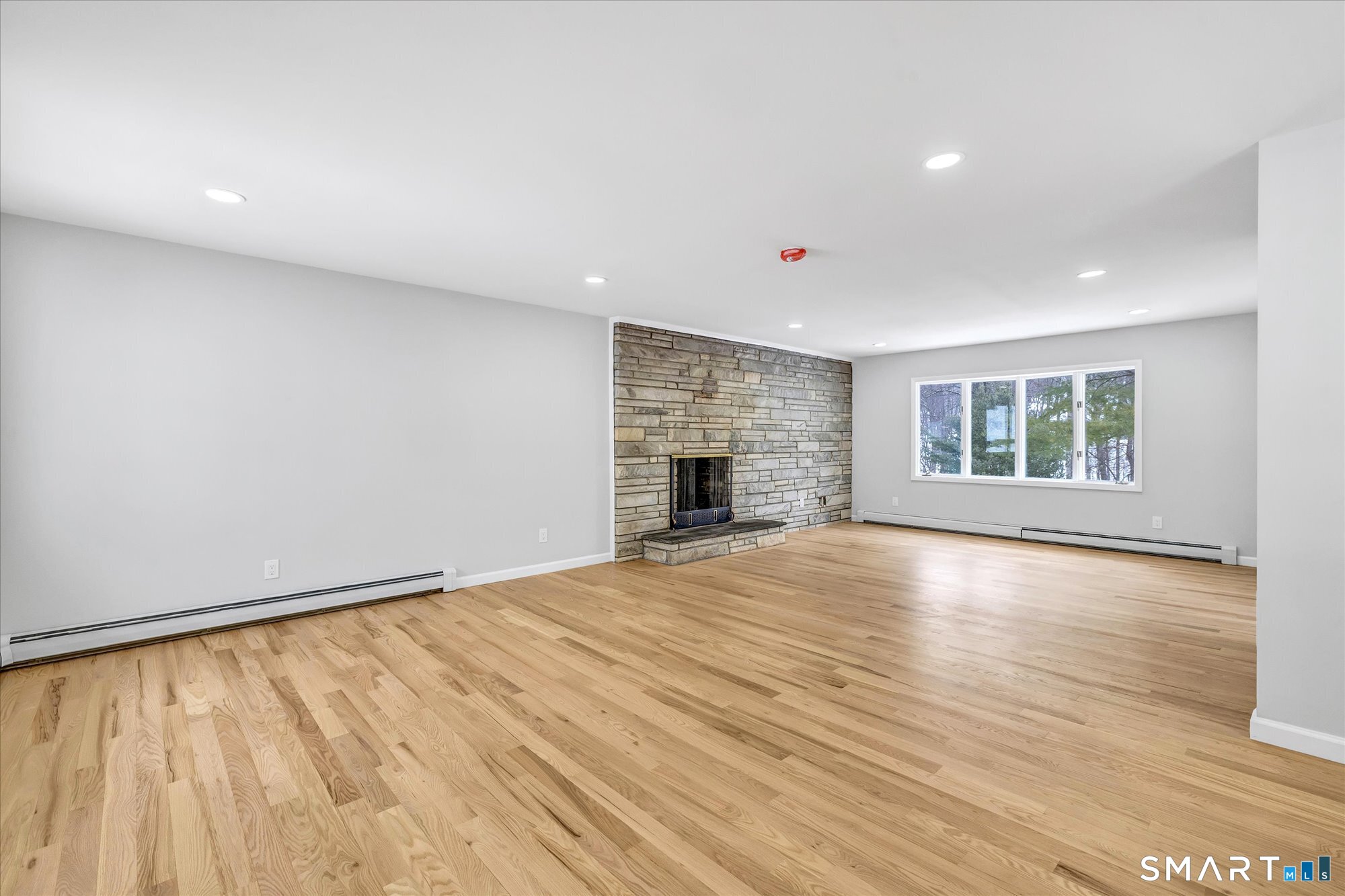 176 Strobel Road Trumbull, CT 06611 - Photo 13 of 39 an empty room with wooden floor and windows