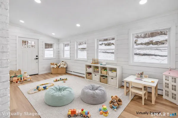 a bedroom with furniture and a large window