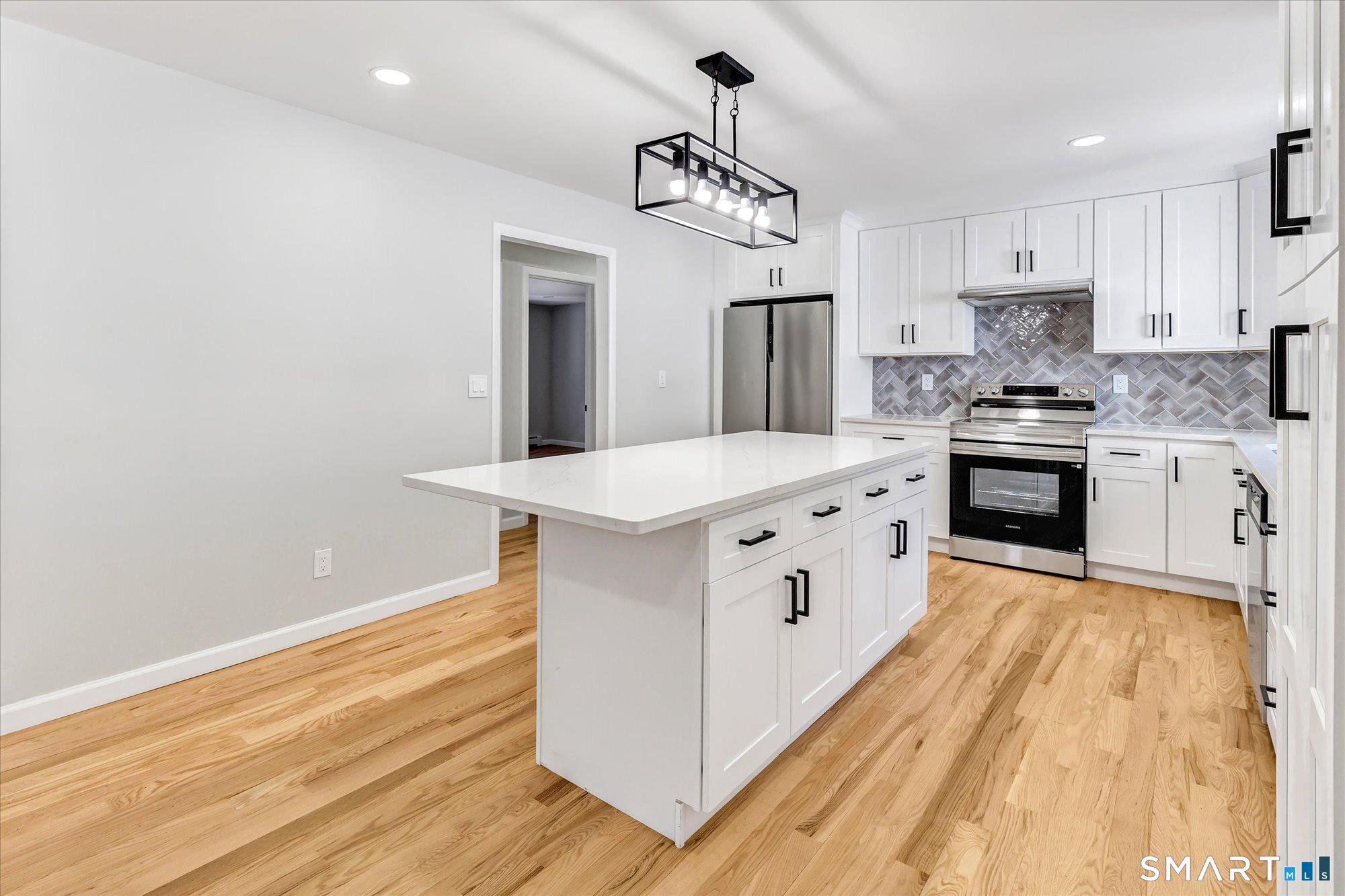 176 Strobel Road Trumbull, CT 06611 - Photo 2 of 39 a kitchen with stainless steel appliances white cabinets and wooden floor