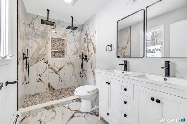 a bathroom with a sink toilet and shower