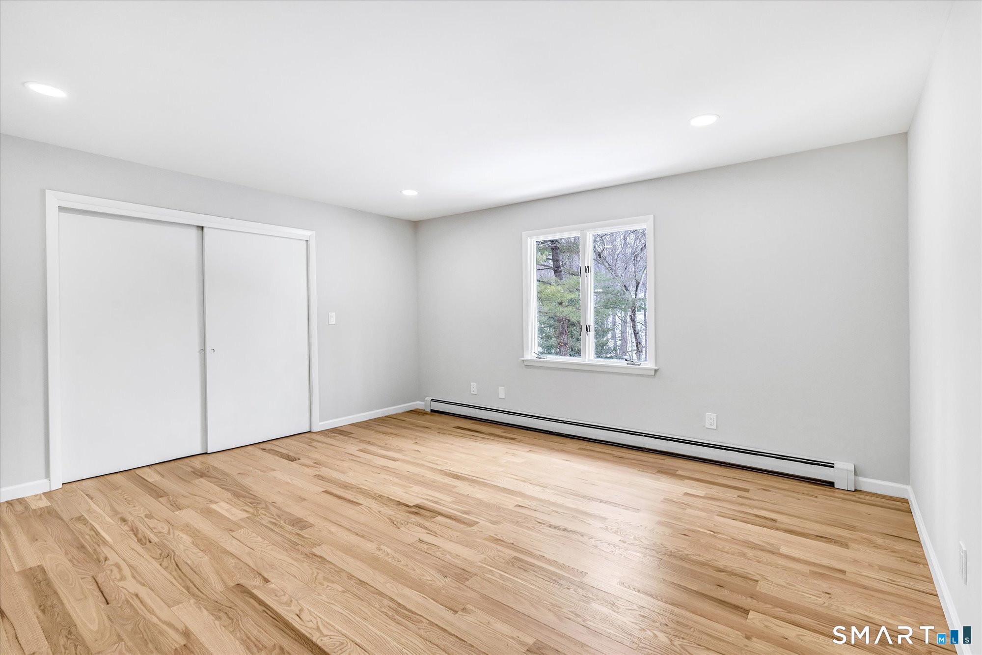 176 Strobel Road Trumbull, CT 06611 - Photo 24 of 39 a view of an empty room with wooden floor and a window