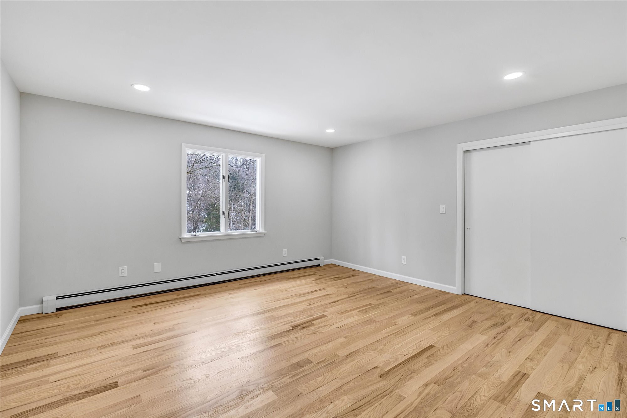 176 Strobel Road Trumbull, CT 06611 - Photo 25 of 39 an empty room with wooden floor and windows