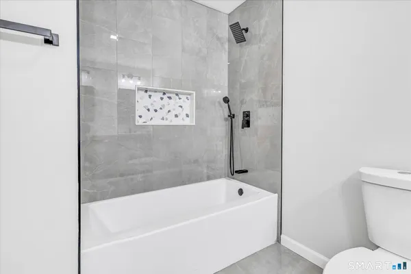 a bathroom with a bathtub and a toilet